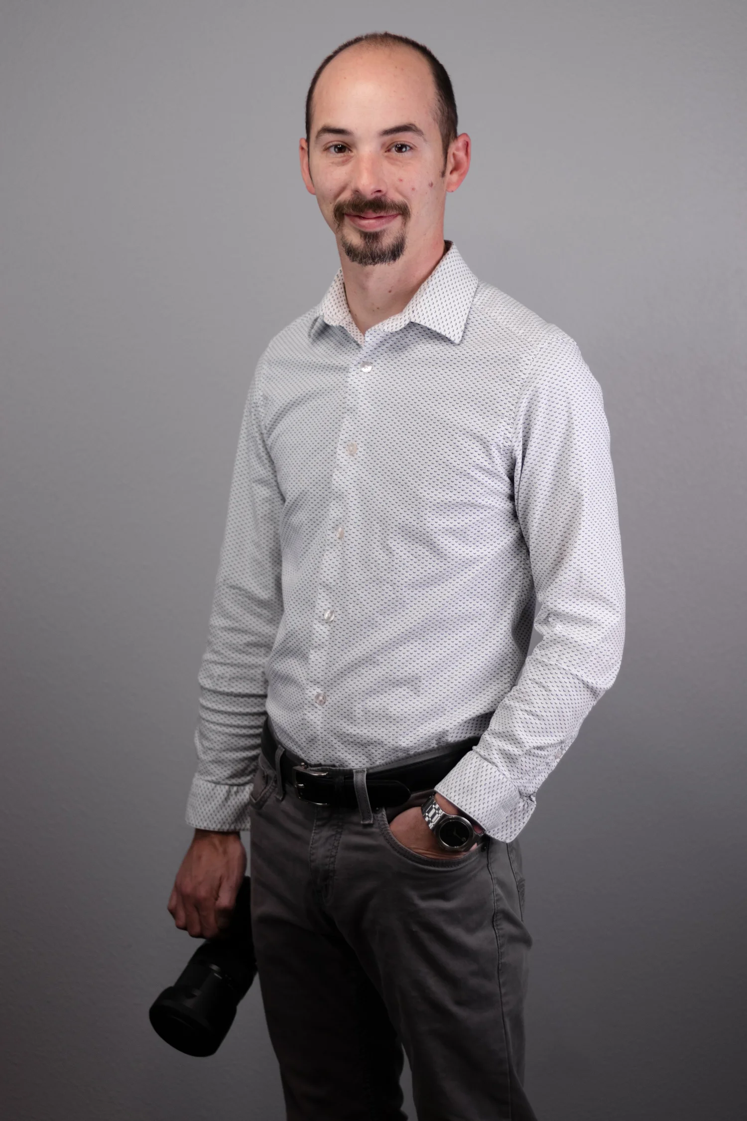 Stephen Sillavan of S and K Imagery holding a camera in the studio